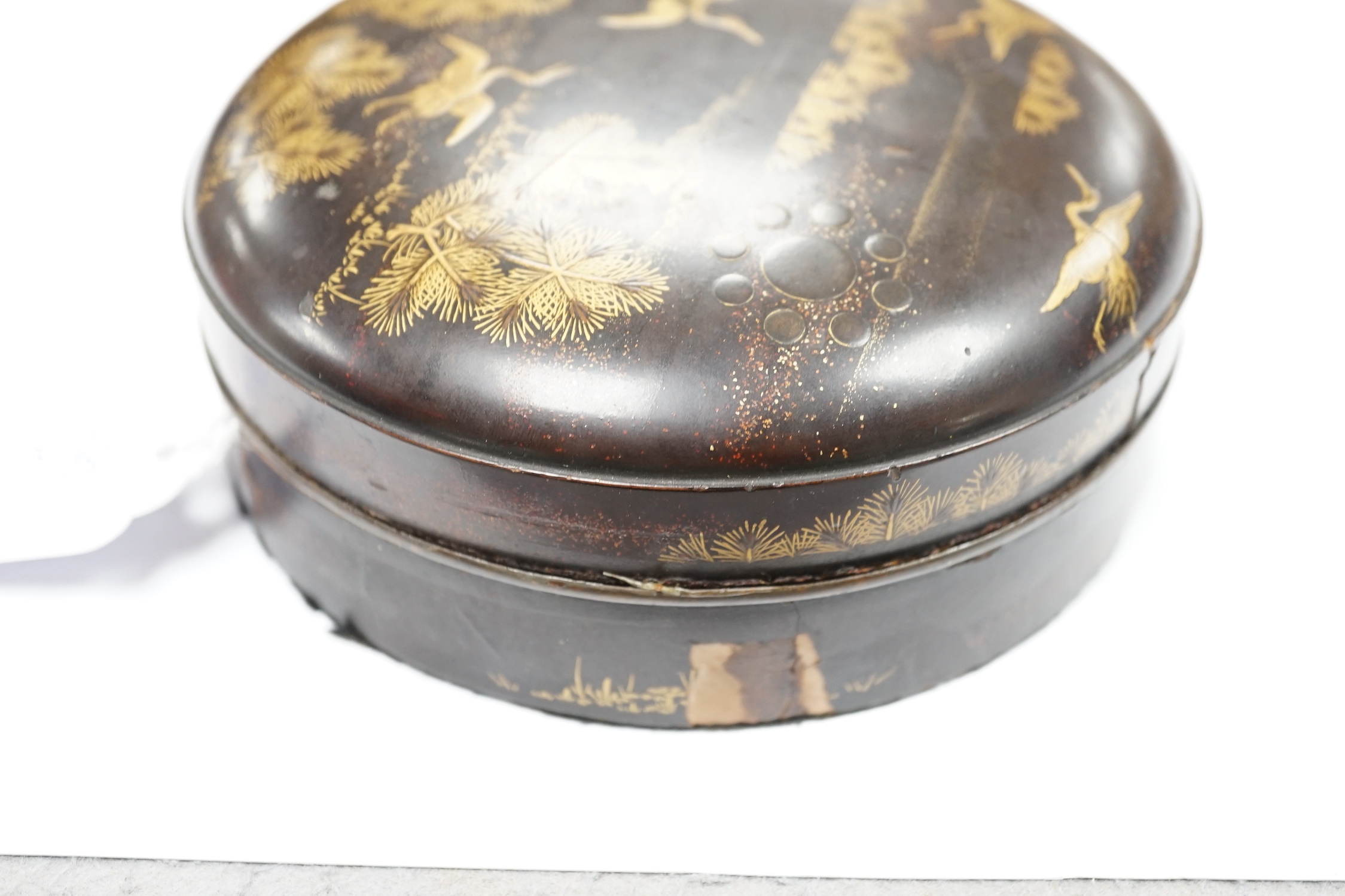 A Japanese cast mirror, housed in a lacquered case, 12cm in diameter